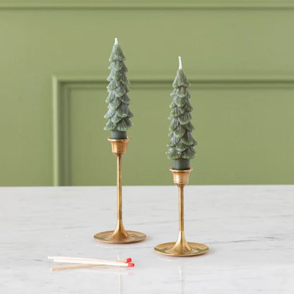 Flamless Taper Candles styled in elegant holders on a marble surface, perfect for festive decor.