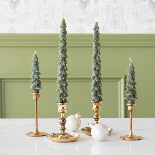 Elegant display of Flamless Taper Candles in festive holders for a holiday atmosphere.